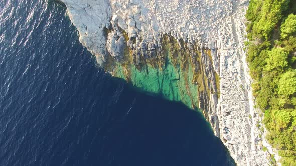 View from above of dangerous Dalmatian cliffs immersed in crystal clear sea alt