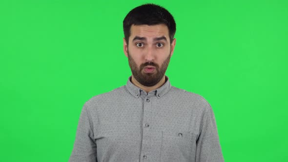 Portrait of Brunette Guy Is Waving His Hands in Indignation, Shrugs. Green Screen alt