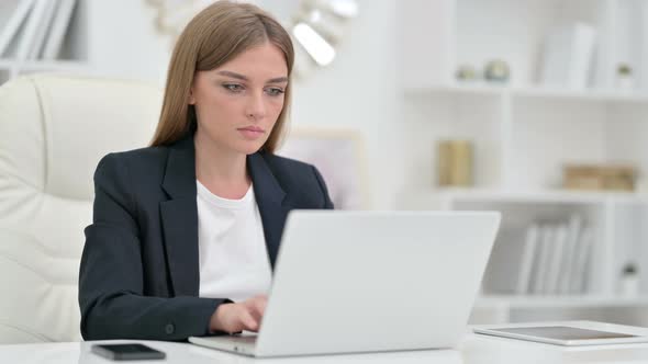 Serious Businesswoman with Laptop Saying No with Head Shake  alt
