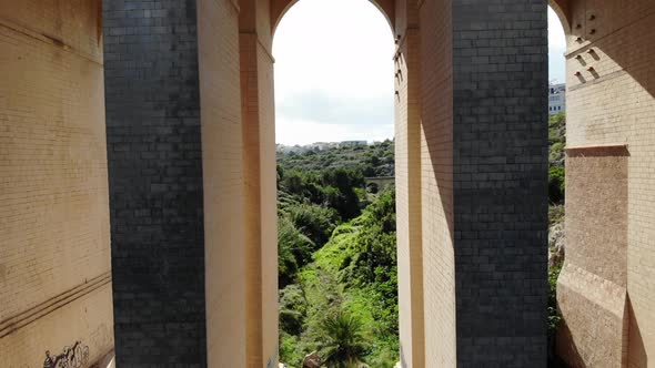 Drone flying under bridge in Malta Nature Valley alt
