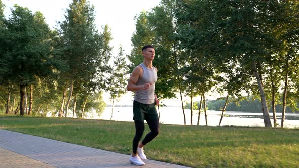 Outdoor Workout of Sporty Man Running in Park Sport Routine alt