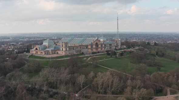 Cinematic circling drone shot around side of alexandra palace and grounds London alt