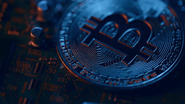 Golden Bitcoin Coin on Green Circuit Background alt