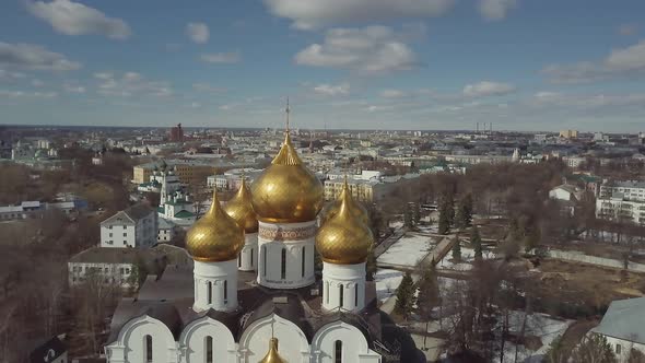 Aerial Footage of Soviet Orthodox Church. Drone Flies Around Golden Domes on Background of City