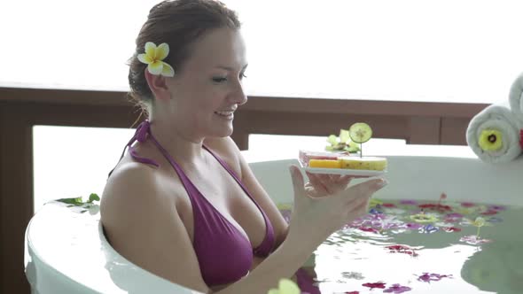 Young Woman Eating Fruits in Spa