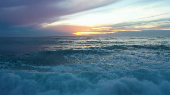 Sea Waves at a Bright Juicy Sunset Filmed Over a Drone alt
