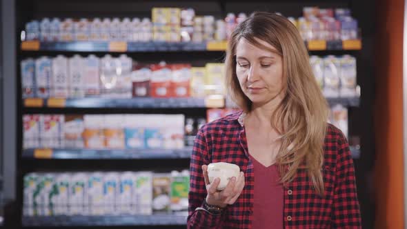 Adult Woman Standing in Supermarket with Fresh Food in Hands