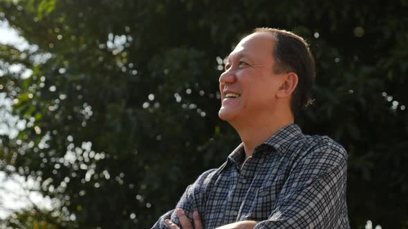 Close Up Of Happy Asian Old Man With Nature Background alt