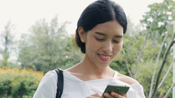 Beautiful Asian young woman shot surfing the net online.