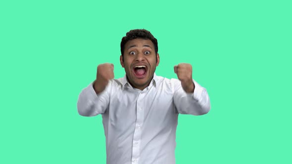 Happy Overjoyed Businessman on Turquoise Background. alt