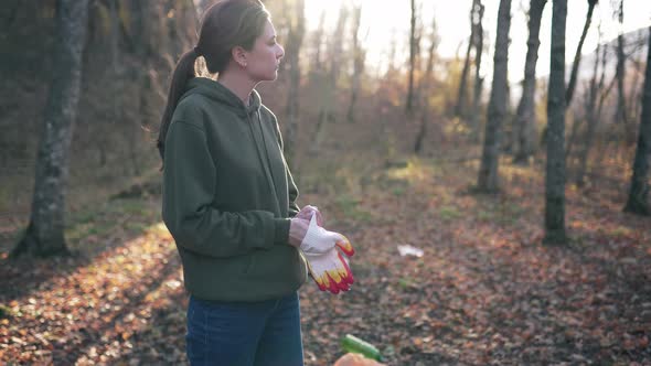 Preparation for the Collection of Garbage and Plastic Waste in the Autumn Forest. Young Woman