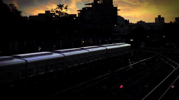 Passenger Train in Motion on the Railway at the Sunset. alt