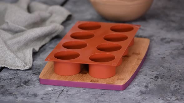 Pouring Chocolate Mousse Into Silicone Molds
