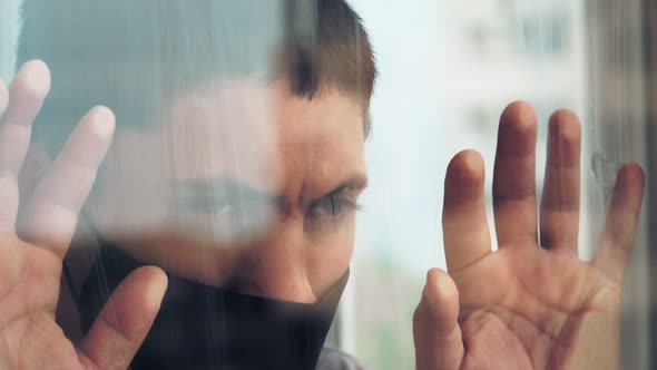 guy medical mask closed window during quarantine isolation home due coronavirus alt