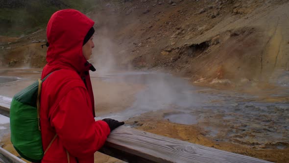 dramatic iceland landscape scenery, geothermal hot spring steam smoke rising from the ground, female alt