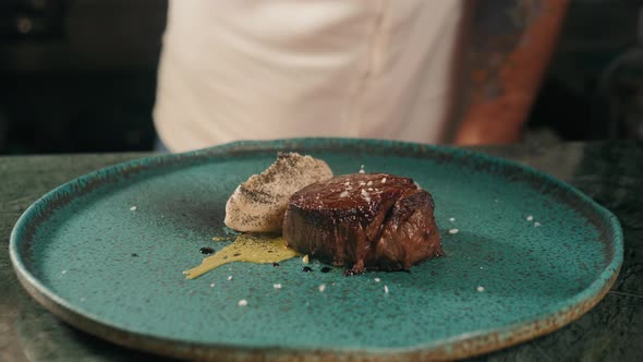 Chef Cooking Juicy Raw Beef Steak at Restaurant Kitchen. Male Chef Cooking and Serving Juicy Medium alt