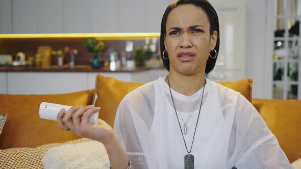 Young African American Woman Watching a Horror Movie alt