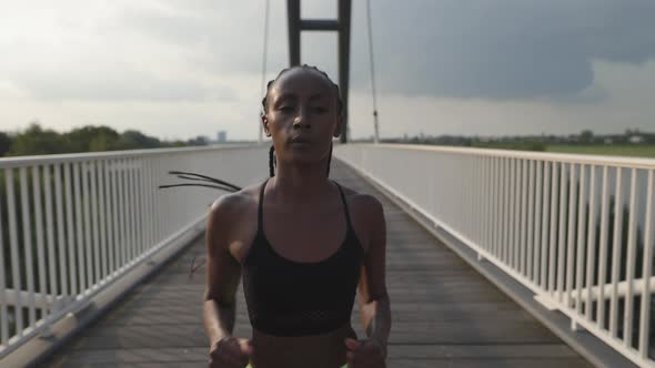 Fit African American Woman Jogging at Urban Area alt