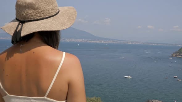 Young Female Tourist Admires the Beautiful View of the Sea and Mountains alt