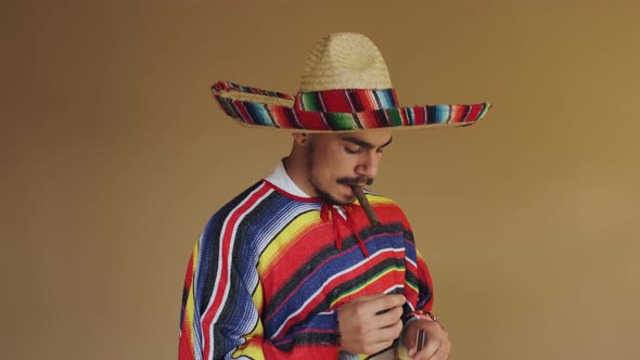 Young Mexican In Multicolored Poncho And Hat alt