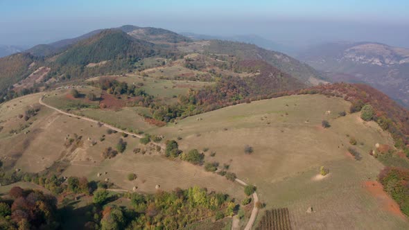 Autumn mountain with peaks, meadows and colorful forests alt