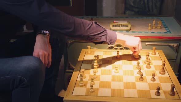 The hands of two chess players move the pieces alternately, taking some chess pieces off the chess b alt