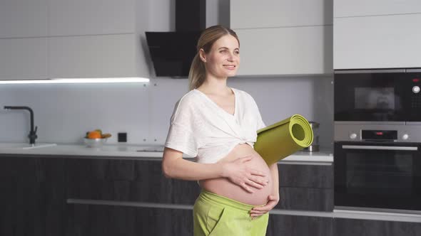 Closeup of a Cute Pregnant Woman Stroking Her Belly of a Mothertobe Expecting a Baby Standing with a