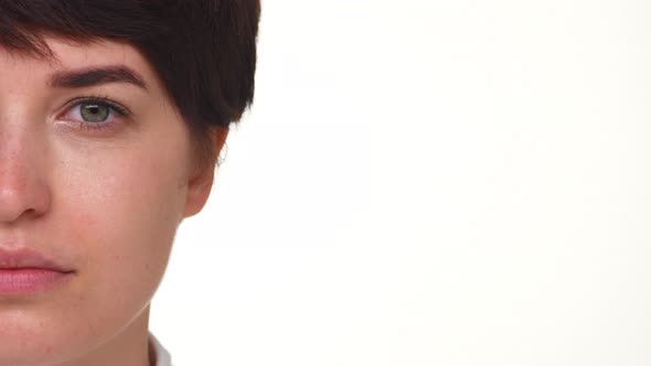 Side Portrait of Calm Girl Opening Eyes Isolated Over White Background Closeup alt