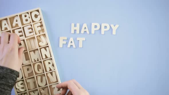 Unfinished wood letters sign Happy Father's Day on a painted wood background alt