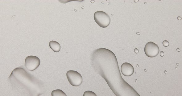 Abstract water drops on grey silver background, macro