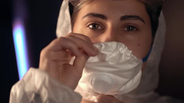 Female Doctor During a Coronavirus Pandemic Covid-19 Takes on and a Protective Mask. Close Up