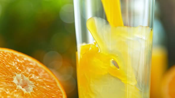 Super Slow Motion Shot of Fresh Orange Juice Being Poured in a Glass at 1000Fps alt