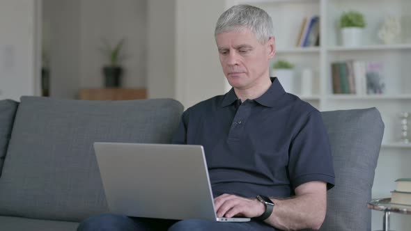 Middle Aged Man Working on Laptop alt