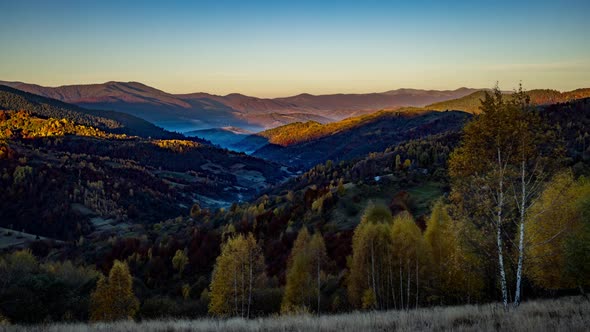 Sun Illuminates Highland with Mountains and Hills in Morning alt
