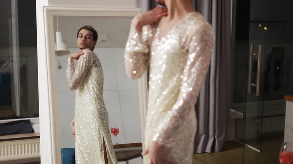 Sensual Man in a Dress Admires Himself Standing in Front the Mirror Slow Motion alt