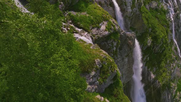 Aerial View Close Up Flight with Mountain Waterfalls Flowing From Glacier Over Rocks alt
