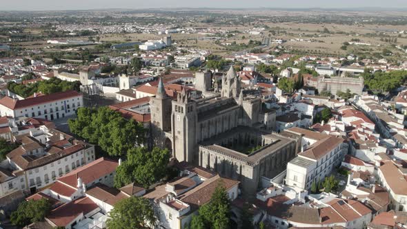 Ancient Cathedral in historic center Evora and cityscape, Portugal. Aerial circling