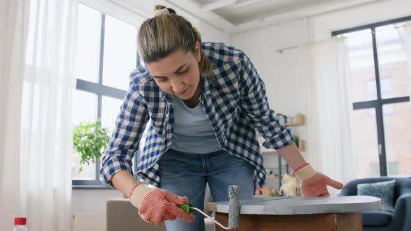 Woman Painting Old Wooden Table with Grey Color alt