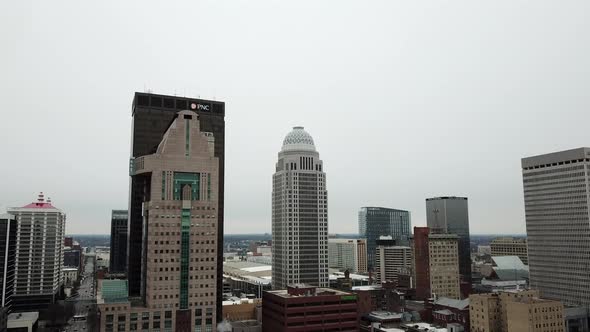 4k aerial view of drone flying toward downtown Louisville, Kentucky skyline on a winter day