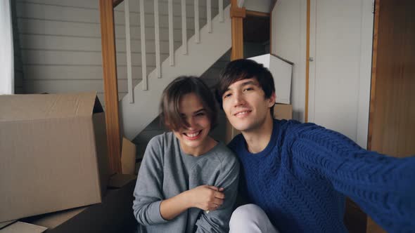 Point of View Shot of Good-looking Man Taking Selfie with His Pretty Wife in New Home Kissing alt