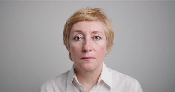 Mature Middle Aged Woman with Beautiful Face Looking at Camera. alt