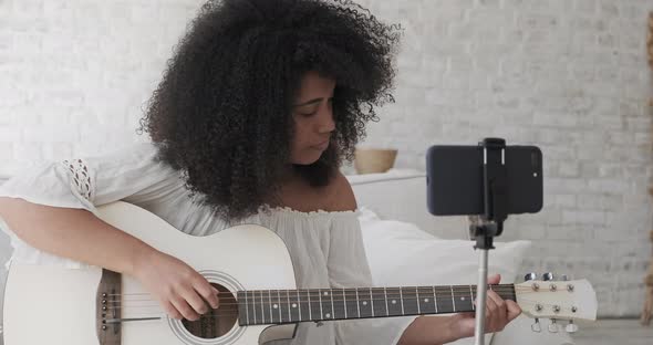 Female Black Vlogger Influencer Playing Guitar and Recording Tutorial alt