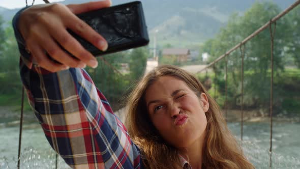 Woman Tourist Taking Selfie Using Mobile Phone at Mountains Nature Background alt