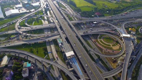 Aerial View of Highway Road Interchange with Busy Urban Traffic Speeding on Road alt