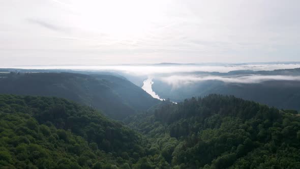 The lush, picturesque moselle valley on a bright cloudy morning. Cinematic wide angle pull back shot alt