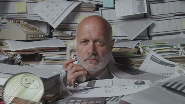 Sad frustrated business executive overwhelmed by work