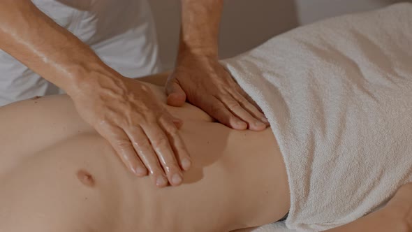 Closeup Male Hands Making Massage for Man Belly