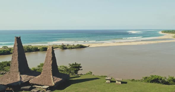 Closeup Ornated Roofs Houses at Traditional Village on Sand Ocean Coast Aerial alt