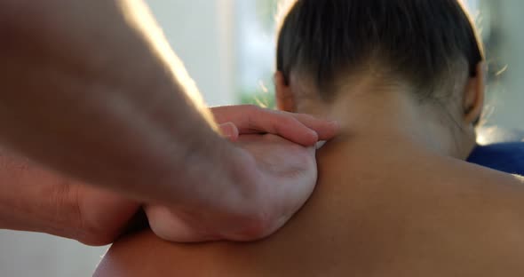Male Physiotherapist Giving Back Massage to Female Patient alt
