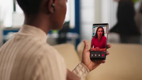 African Woman Explaining Financial Reports to Remote Manager on Webcam alt